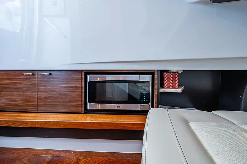 Slide: The Image of Modern interior of 2020 Pursuit S 368 Sport with built-in microwave and sleek cabinetry. - 47
