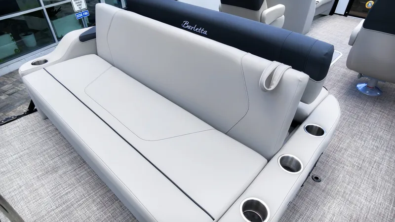 Slide: The Image of The image shows a luxurious bench seat on a Barletta SANZA 22UC boat with cup holders. - 10