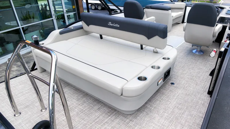 Slide: The Image of The image shows the deck of a Barletta SANZA 22UC boat with sleek seating and cup holders. - 8
