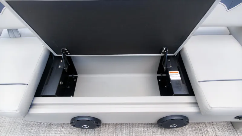 Slide: The Image of An open storage compartment on a Barletta SANZA 22UC boat, revealing a spacious interior. - 11