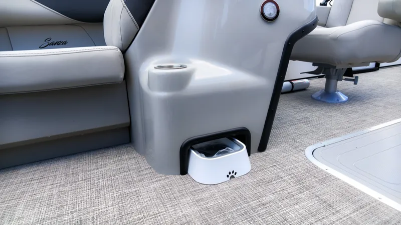 Slide: The Image of The image shows the interior of a Barletta SANZA 22UC boat with a built-in dog bowl. - 18