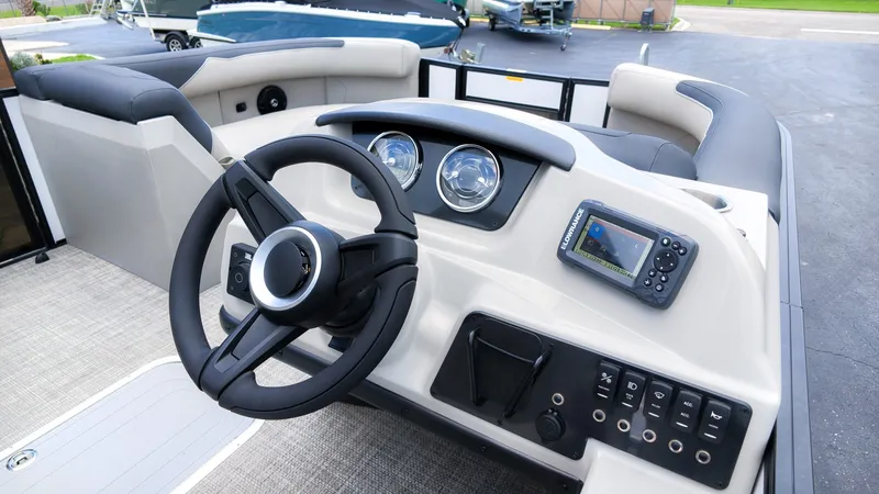Slide: The Image of The image shows the helm of a Barletta SANZA 22UC boat with modern instruments. - 21