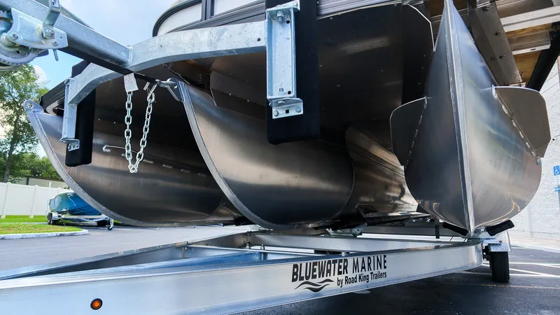 Slide: The Image of Close-up of a Barletta SANZA 22UC pontoon boat on a trailer, showing its aluminum hulls. - 3