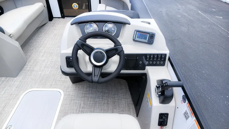 Slide: The Image of The image shows the helm of a Barletta SANZA 22UC boat with a steering wheel and instruments. - 20