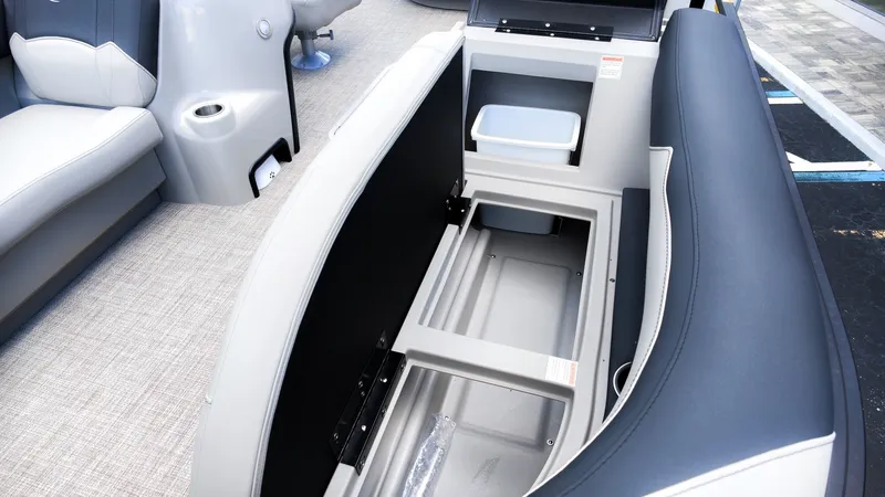 Slide: The Image of The image shows the interior of a Barletta SANZA 22UC boat with gray upholstery and storage space. - 15