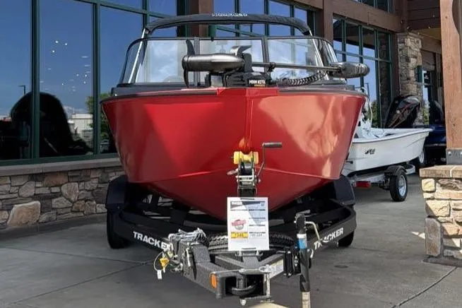 Slide: The Image of 2026 Tracker Pro Guide V-175 WT boat in showroom, red exterior, on trailer. - 2