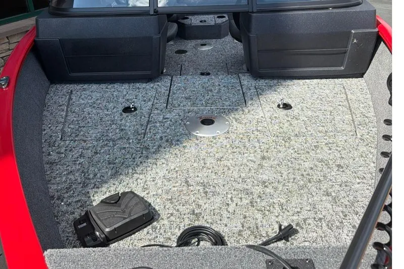 Slide: The Image of 2026 Tracker Pro Guide V-175 WT boat interior with carpeted deck and storage compartments. - 5