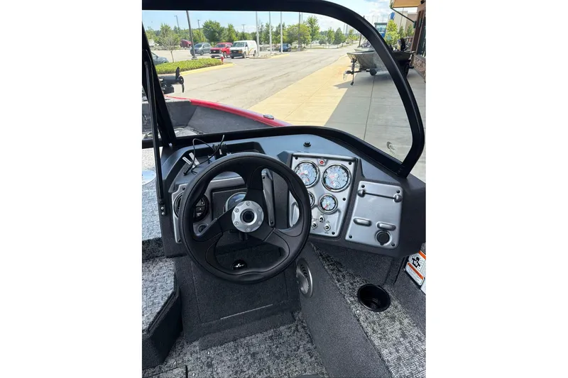 Slide: The Image of Interior view of 2026 Tracker Pro Guide V-175 WT boat dashboard with steering wheel and gauges. - 69