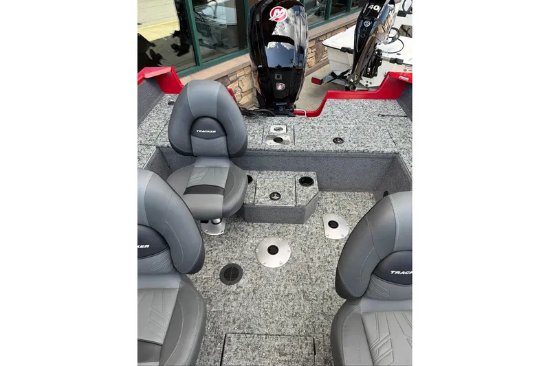 Slide: The Image of Interior of 2026 Tracker Pro Guide V-175 WT boat with gray seating and motor. - 72