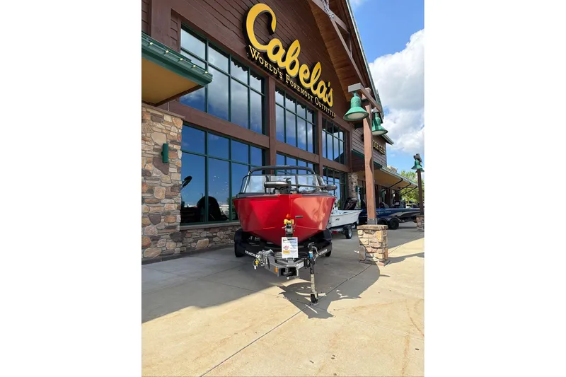 Slide: The Image of 2026 Tracker Pro Guide V-175 WT boat displayed outside Cabela's store. - 66