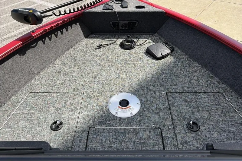 Slide: The Image of 2026 Tracker Pro Guide V-175 WT boat interior with carpeted deck and fishing equipment. - 4