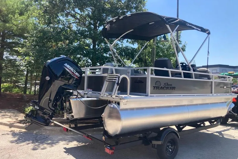 Slide: The Image of 2026 Sun Tracker Bass Buggy 18 DLX pontoon boat with Mercury outboard motor on trailer. - 3