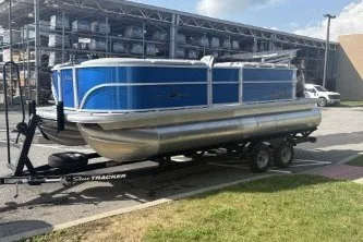 The Image of 2026 Sun Tracker Party Barge 20 DLX pontoon boat on trailer in parking lot. - 0