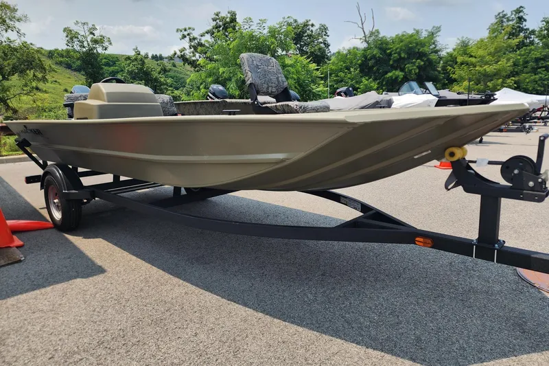 Slide: The Image of 2026 Tracker Grizzly 1754 SC boat on trailer, parked outdoors on a sunny day. - 1