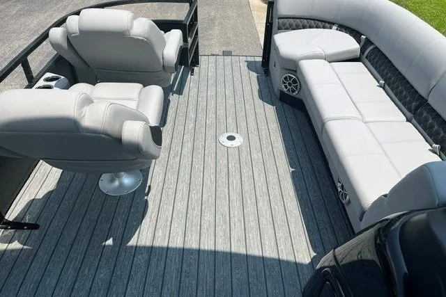 Slide: The Image of 2026 Ranger 220FC boat interior with gray seating and flooring. - 11