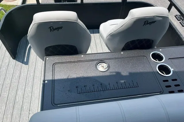 Slide: The Image of 2026 Ranger 220FC boat interior with seating, measuring board, and cup holders. - 6