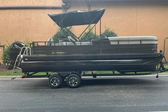The Image of 2026 Ranger 220FC pontoon boat on trailer, featuring a sleek black design and canopy. - 0