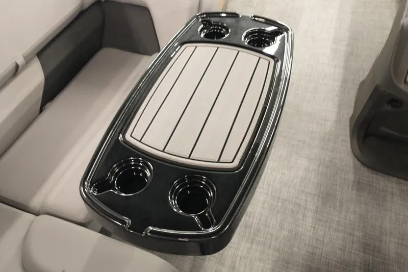 Slide: The Image of 2026 Sun Tracker SportFish 20 DLX boat interior with sleek table and cup holders. - 5