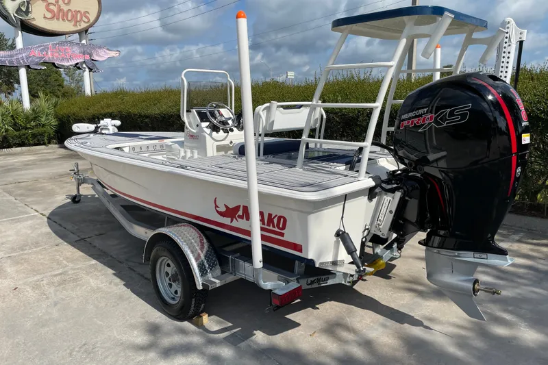Slide: The Image of 2026 Mako 18 Pro Skiff Patriot Edition boat with Mercury Pro XS engine on trailer. - 3