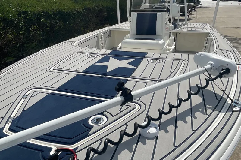 Slide: The Image of 2026 Mako 18 Pro Skiff Patriot Edition with star design on deck, featuring advanced trolling motor. - 2