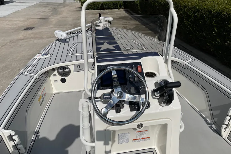 Slide: The Image of 2026 Mako 18 Pro Skiff Patriot Edition boat interior with steering console and controls. - 12