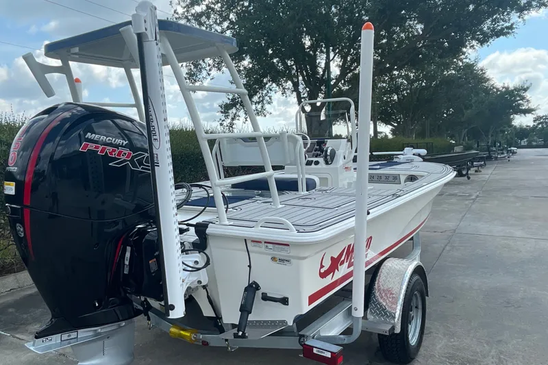 Slide: The Image of 2026 Mako 18 Pro Skiff Patriot Edition with Mercury Pro XS engine on trailer. - 104