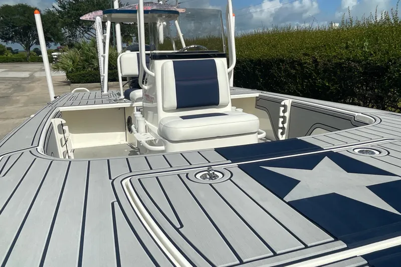 Slide: The Image of 2026 Mako 18 Pro Skiff Patriot Edition with star design on deck, featuring comfortable seating. - 15