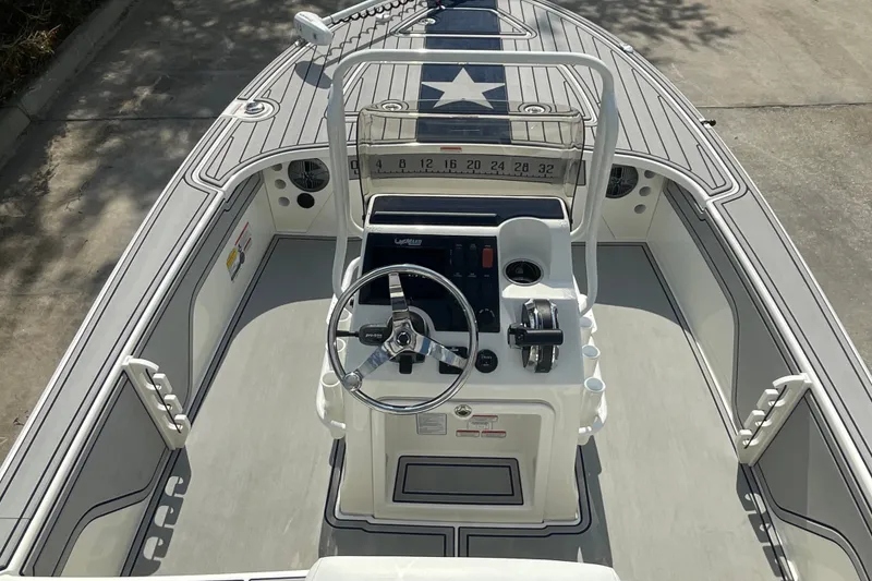 Slide: The Image of 2026 Mako 18 Pro Skiff Patriot Edition boat interior with steering wheel and control panel. - 11
