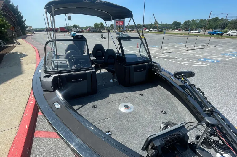 Slide: The Image of 2026 Tracker Targa V-19 WT boat parked in a lot, showcasing interior and seating. - 2