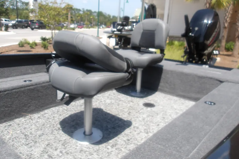 Slide: The Image of 2026 Tracker Super Guide V-16 T boat interior with gray seating and motor. - 12