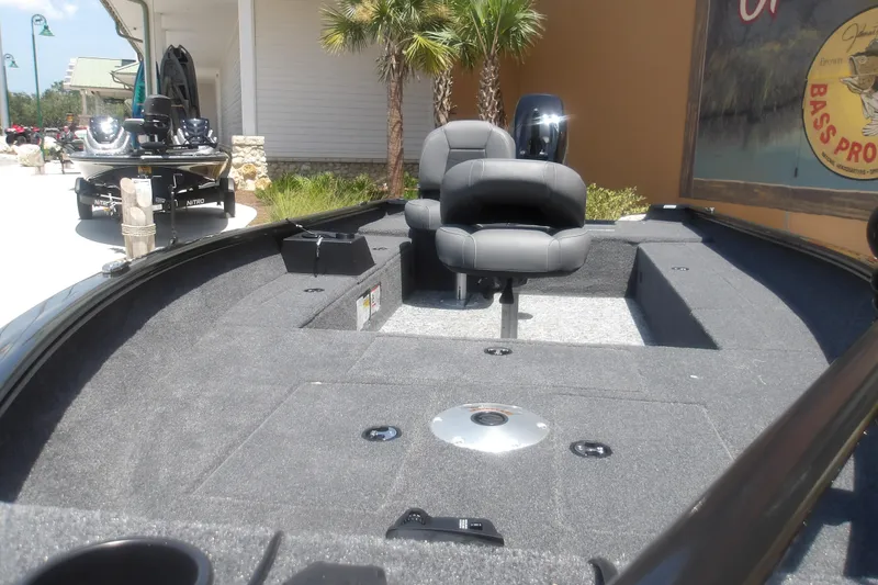 Slide: The Image of 2026 Tracker Super Guide V-16 T boat interior with seating and carpeted deck. - 15