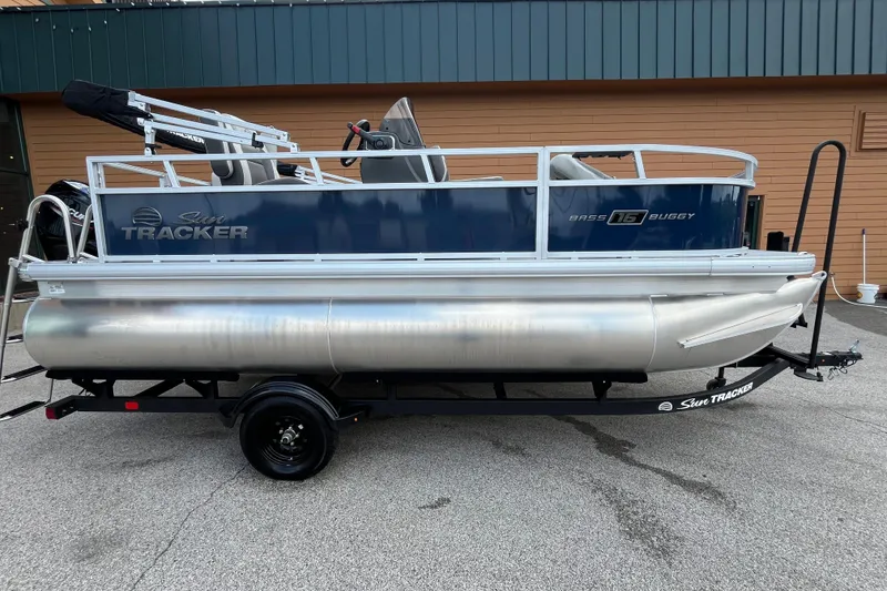 The Image of 2026 Sun Tracker Bass Buggy 16 XL Select pontoon boat on trailer, side view. - 0
