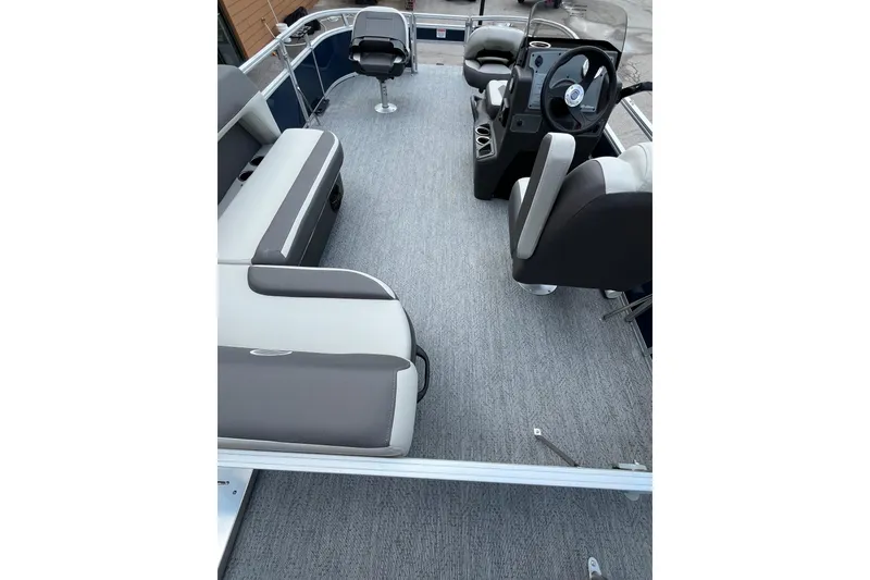 Slide: The Image of 2026 Sun Tracker Bass Buggy 16 XL Select interior with seating and steering console. - 3
