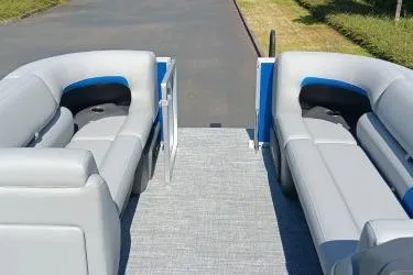 Slide: The Image of 2026 Sun Tracker Party Barge 20 DLX interior with gray seating and open deck view. - 7