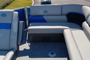 Slide: The Image of 2026 Sun Tracker Party Barge 20 DLX interior with comfortable seating and modern design. - 6