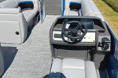 Slide: The Image of 2026 Sun Tracker Party Barge 20 DLX interior with steering console and seating. - 9