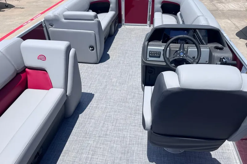 Slide: The Image of 2026 Sun Tracker Party Barge 20 DLX interior with plush seating and modern helm. - 3