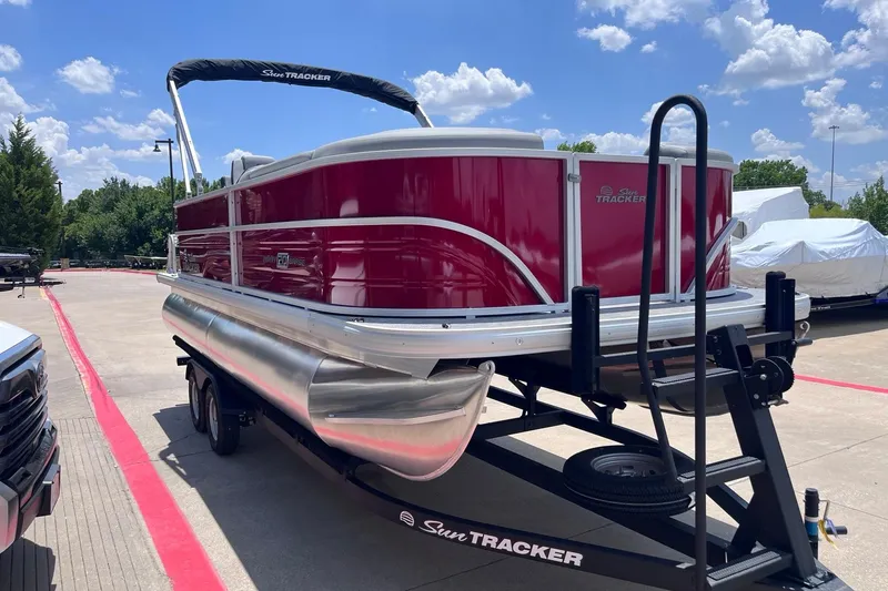 Slide: The Image of 2026 Sun Tracker Party Barge 20 DLX pontoon boat on trailer, sunny day. - 5