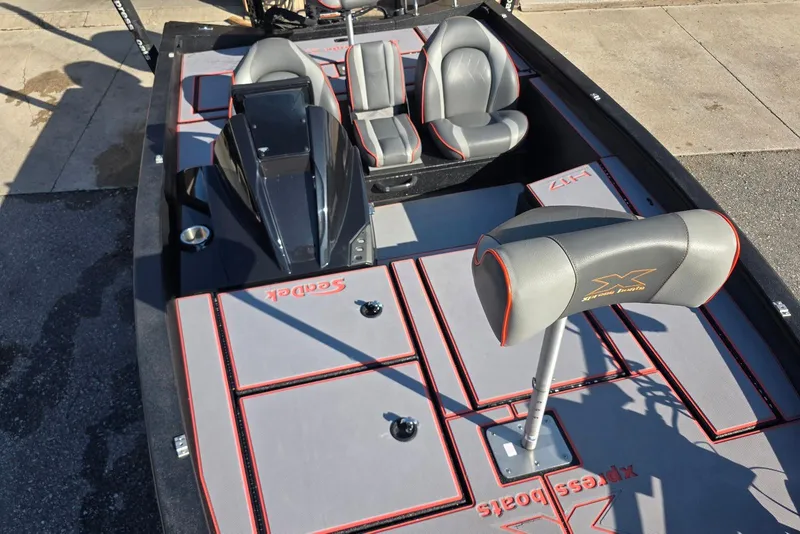 Slide: The Image of 2023 Xpress H17 boat interior with gray and red seating and deck. - 15