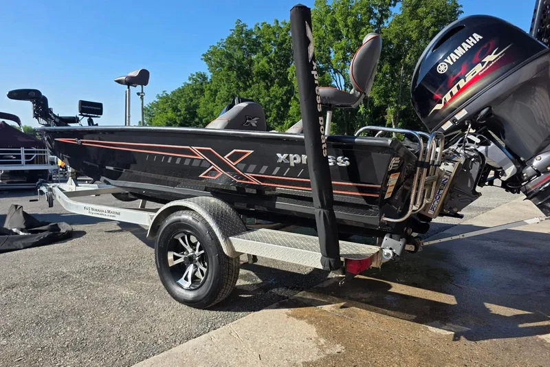 Slide: The Image of 2023 Xpress H17 boat on trailer with Yamaha engine, parked outdoors. - 8