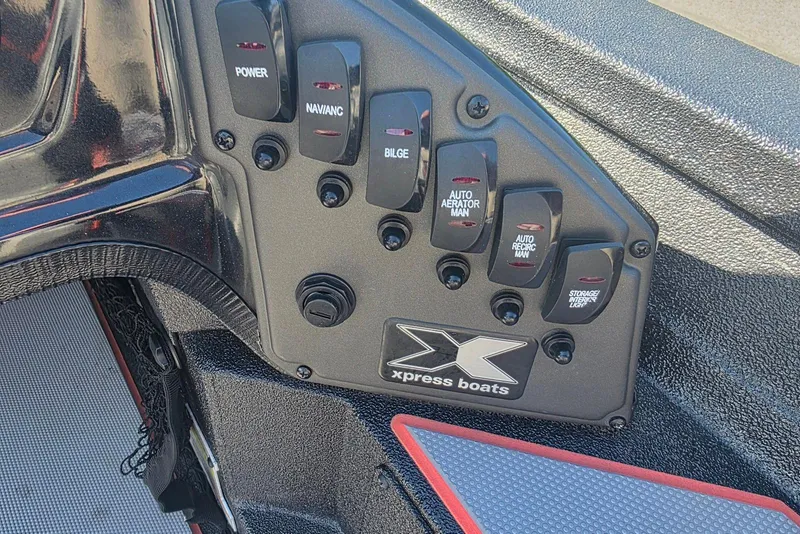Slide: The Image of Control panel of 2023 Xpress H17 boat with labeled switches and logo. - 18