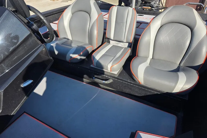 Slide: The Image of 2023 Xpress H17 boat interior with gray and orange-trimmed seats. - 16