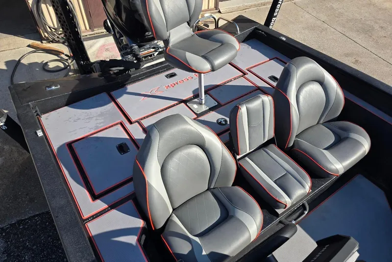 Slide: The Image of 2023 Xpress H17 boat interior with gray and red-trimmed seats. - 20