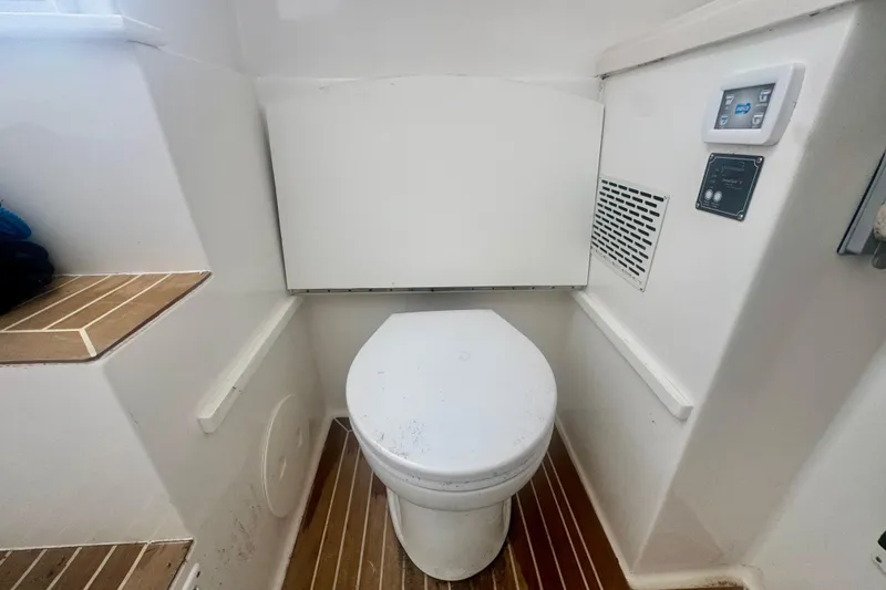 Slide: The Image of 2017 Stamas 390 Tarpon boat interior with a compact marine toilet setup. - 4
