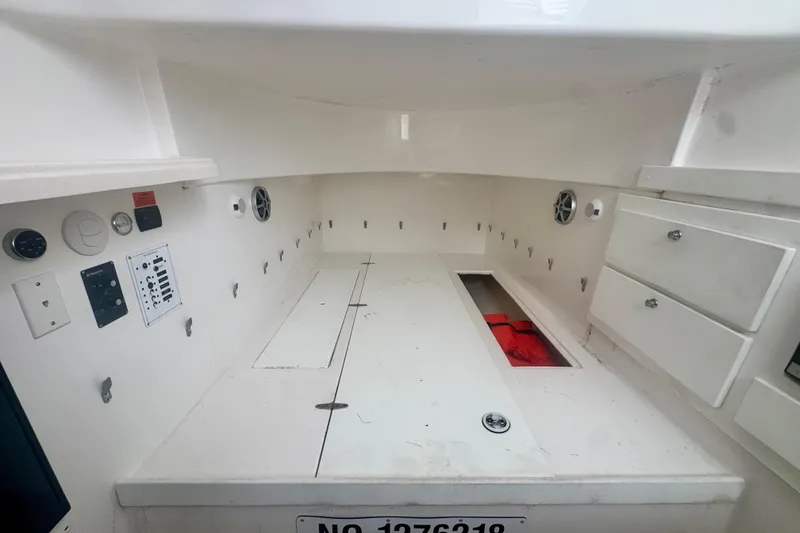 Slide: The Image of 2017 Stamas 390 Tarpon boat interior with storage compartments and control panels. - 7