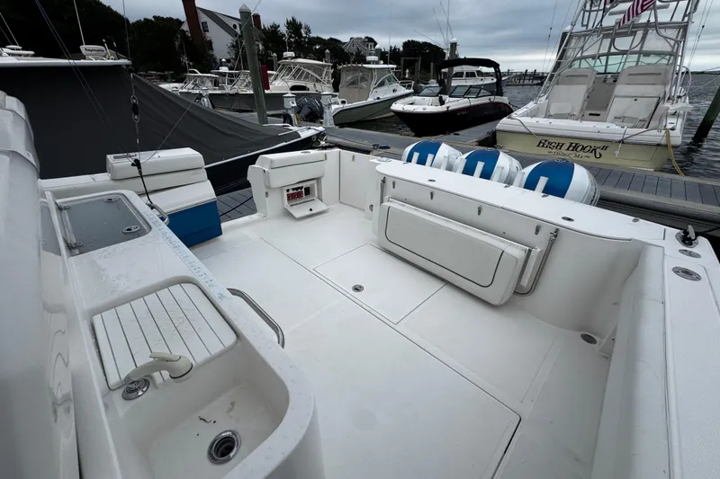 Slide: The Image of 2017 Stamas 390 Tarpon boat interior at dock, featuring spacious seating and fishing amenities. - 12