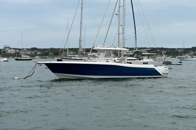 The Image of 2017 Stamas 390 Tarpon boat anchored in a marina with sailboats. - 0