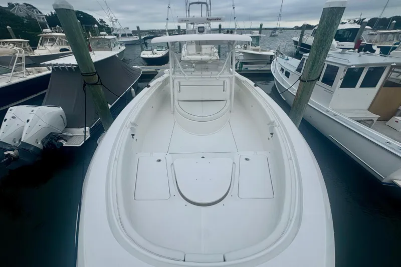Slide: The Image of 2017 Stamas 390 Tarpon boat docked at marina, surrounded by other vessels. - 1