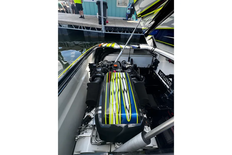 Slide: The Image of Engine compartment of 2022 MTI 48 boat with vibrant custom paint design. - 14