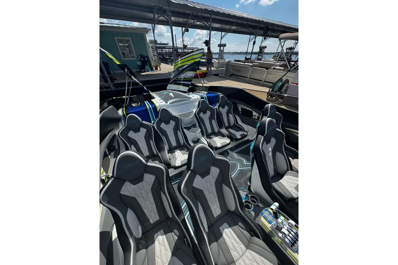 Slide: The Image of Luxury MTI 48 boat interior with sleek seating, docked under a sunny sky. - 4